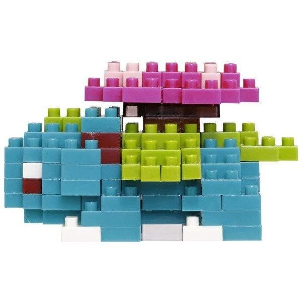 A colorful arrangement of various colored building blocks, including blue, green, and pink, forming a playful and creative structure.