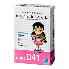 The image is a box containing a figurine of a young girl playing a violin.