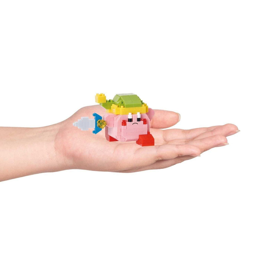 A hand holding a small, colorful toy in the palm.