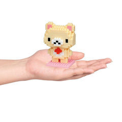 A hand holding a small, pixelated bear figure.
