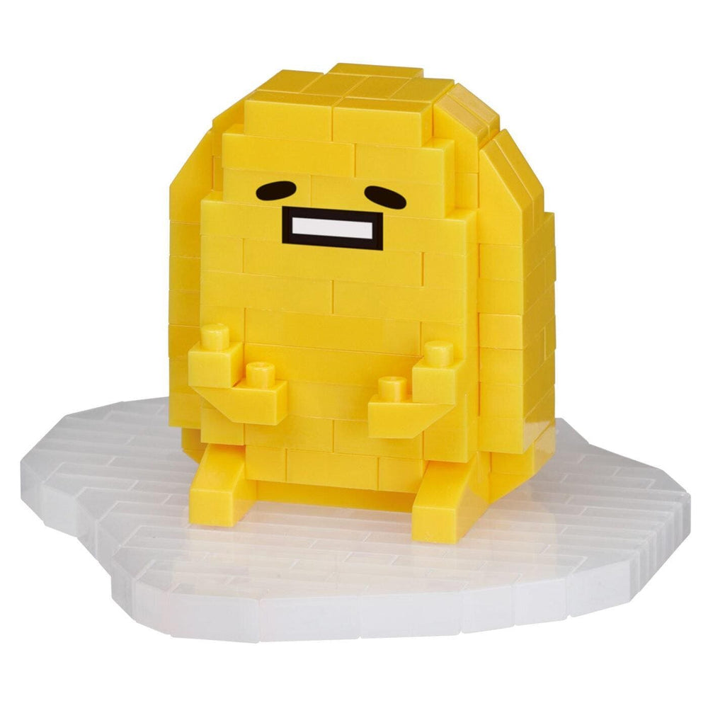 A yellow, pixelated character resembling a smiling egg with a face and arms, sitting on a white surface.