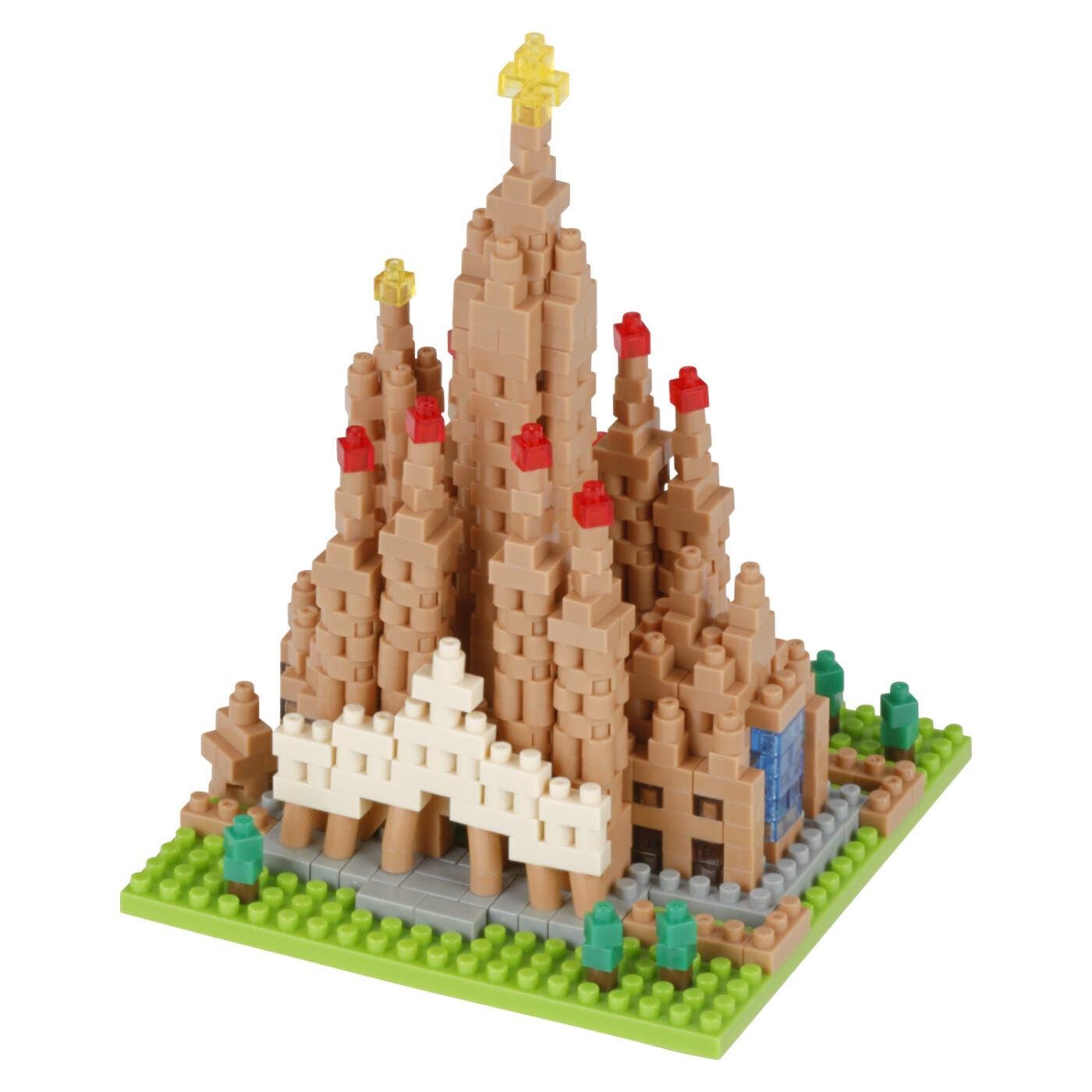 A small, colorful, and intricate model of a castle-like structure made of small building blocks, resembling a Lego or similar toy.