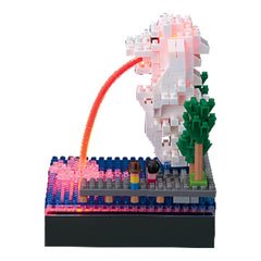A colorful and intricate Lego sculpture depicting a serene scene with a castle-like structure, a castle tower, and a castle gate. The castle is made up of numerous small Lego bricks, creating a detailed and visually appealing miniature landscape.