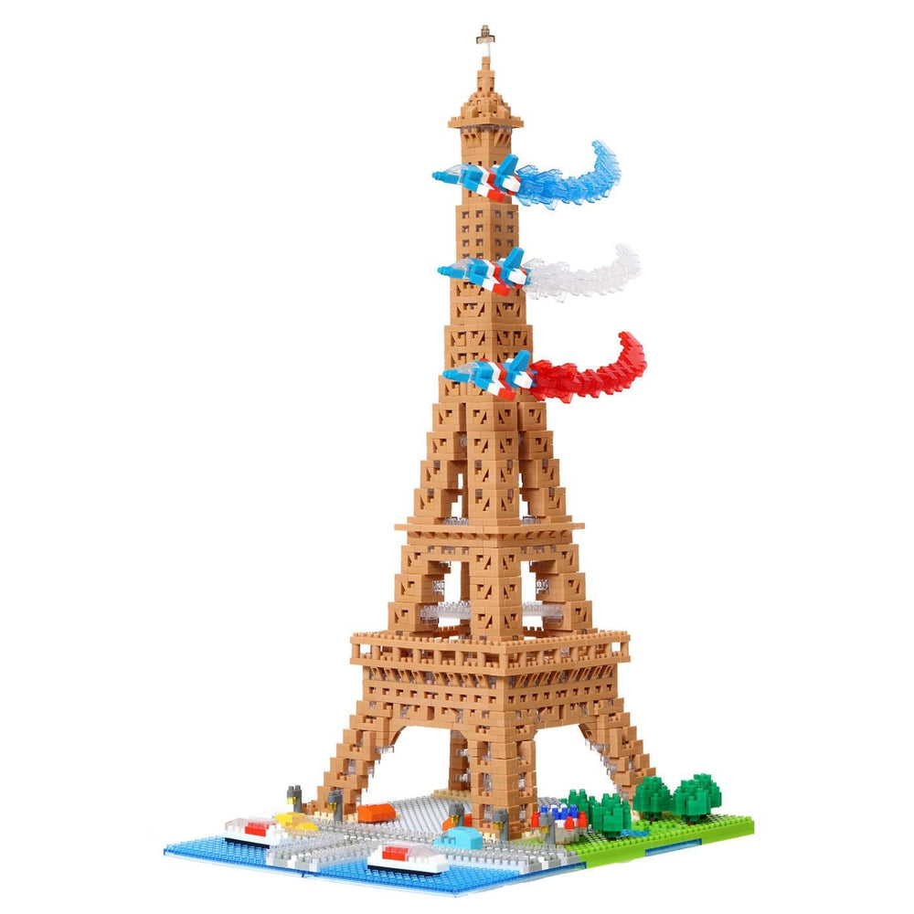 A colorful and intricate model of the Eiffel Tower made of small building blocks, with a French flag and streamers attached to the top.
