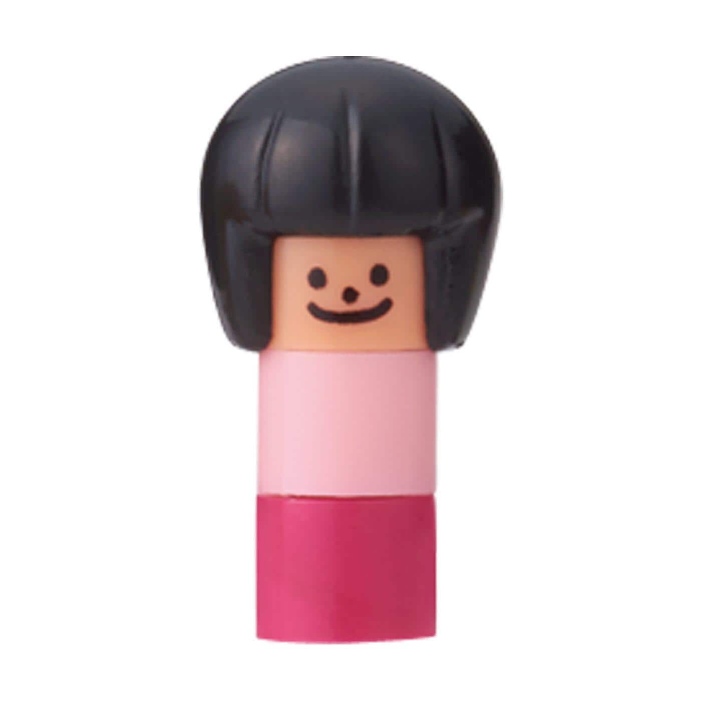 A small, colorful doll with a black hairpiece and a pink dress.