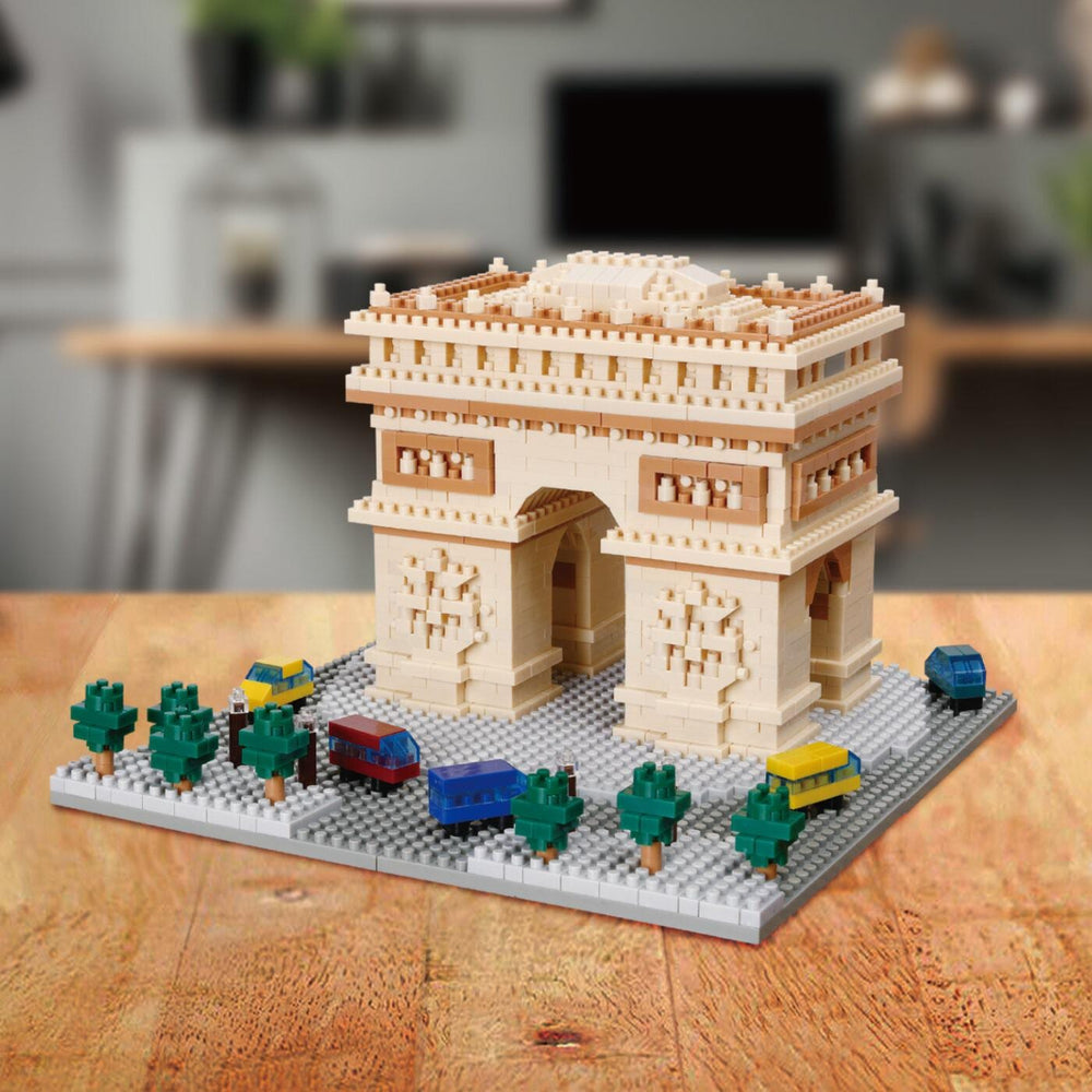 A miniature model of the Eiffel Tower made of building blocks, placed on a wooden surface.