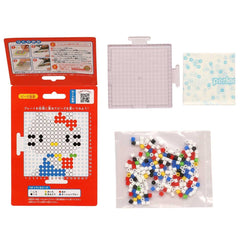 a Hello Kitty puzzle box, a clear plastic bag filled with colorful beads, and a small white square with a blue design.