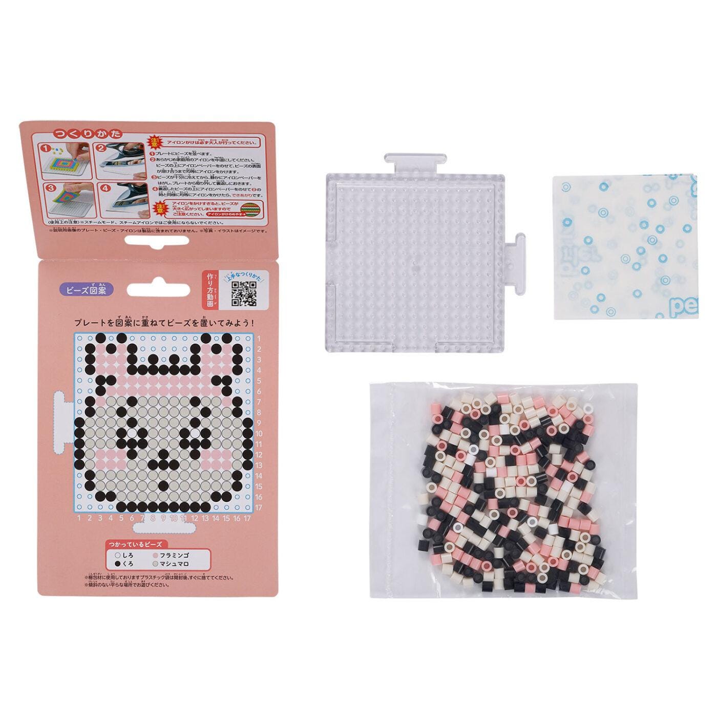 a pink box with instructions for creating a pixel art design, a clear plastic container, and a bag filled with colorful beads.