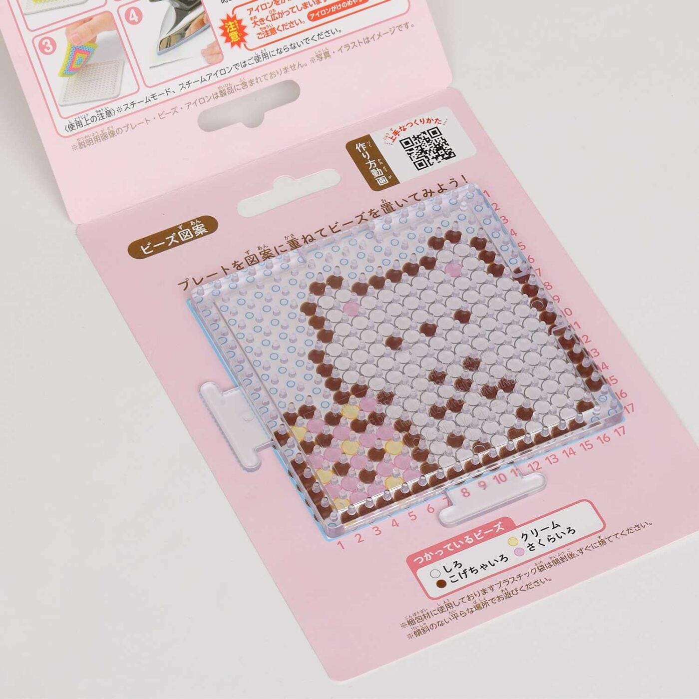 a pink packaging for a product, featuring a clear plastic case with a pattern of small dots and a QR code.