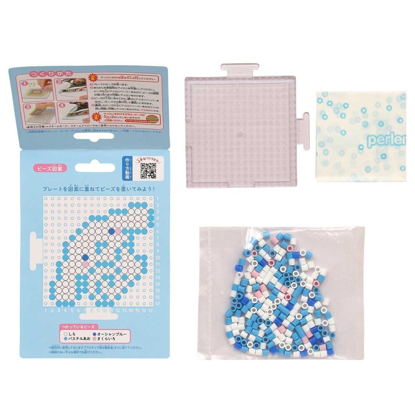 a set of items related to a craft or art project, including a package, a clear plastic container, and a bag filled with small blue and white beads.