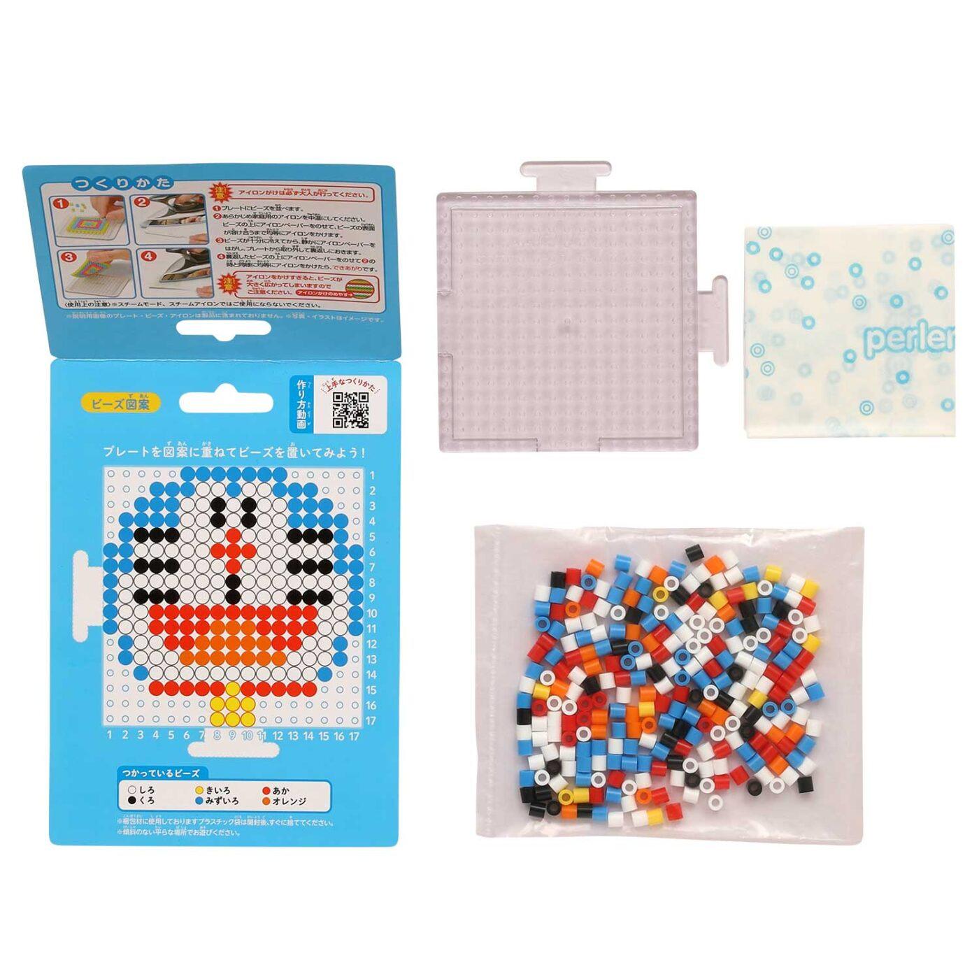 a set of items related to a craft or art project, including a package with instructions, a plastic container with colorful beads, and a clear plastic bag filled with beads.
