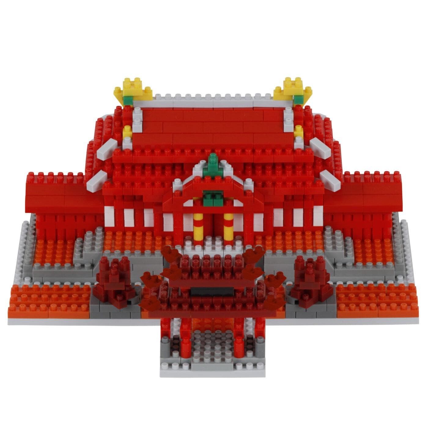 A 3D model of a red and white building made of red and white building blocks, with yellow and green accents.