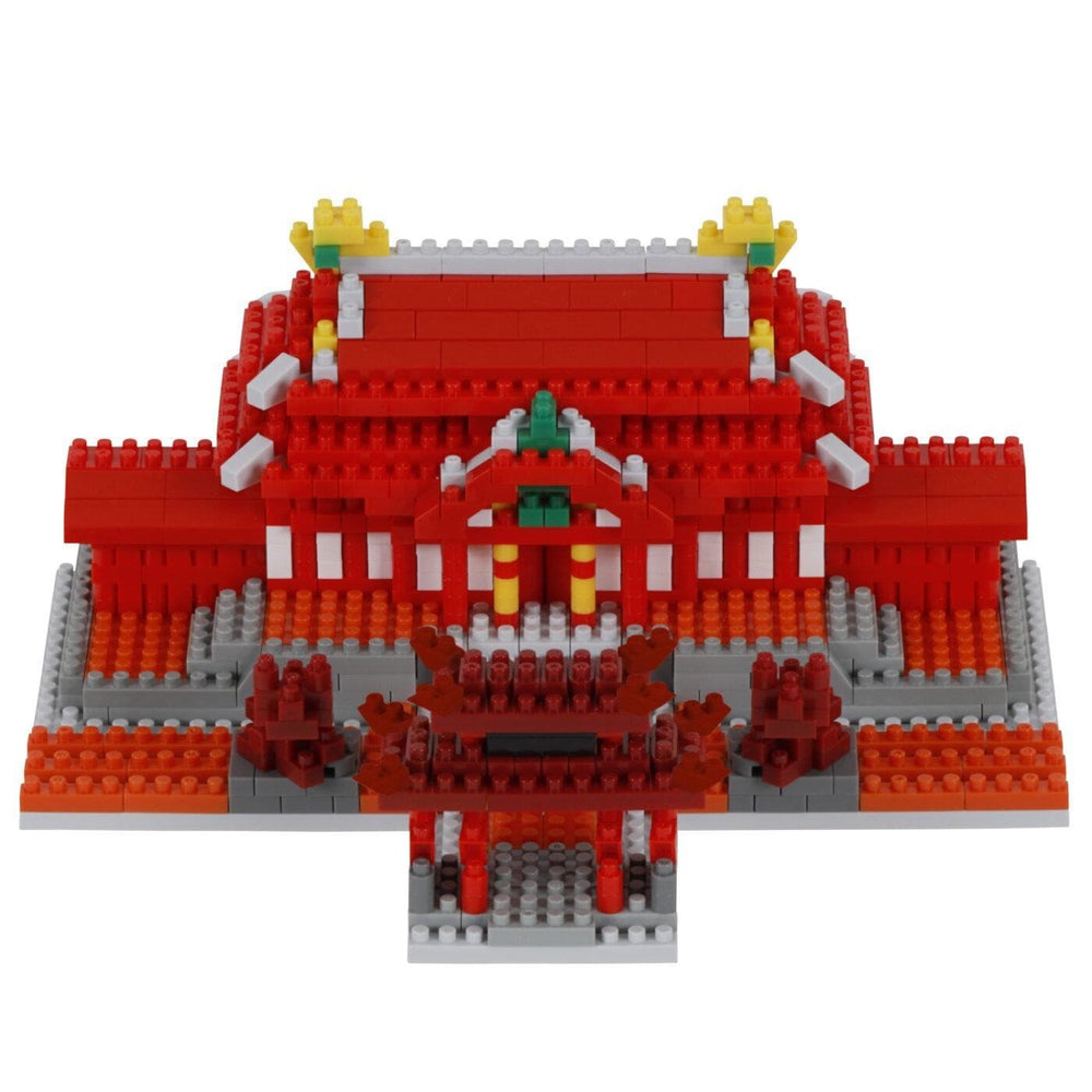 A 3D model of a red and white building made of red and white building blocks, with yellow and green accents.