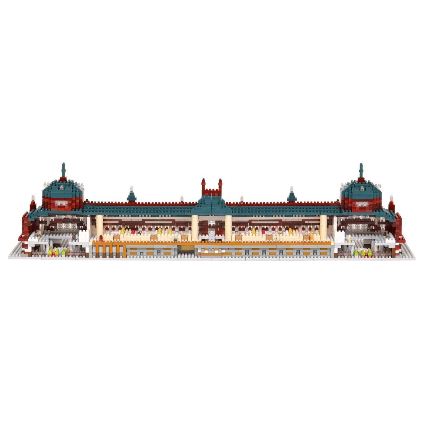A 3D rendering of a large, multi-level building with a distinctive architectural style, featuring a mix of red, green, and yellow colors.