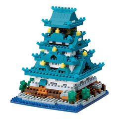 A colorful, multi-level building made of various building blocks in shades of blue, green, and yellow.