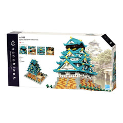 The image is a box containing a set of building blocks designed to resemble the Osaka Castle Deluxe Edition. The box features a collage of images depicting the castle and its surrounding environment, showcasing the intricate details and vibrant colors of the model.