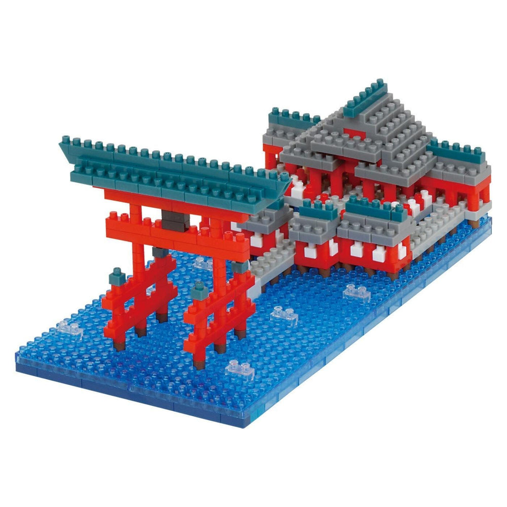 A colorful and intricate model of a Japanese temple made of building blocks, with a red torii gate and a blue water feature.