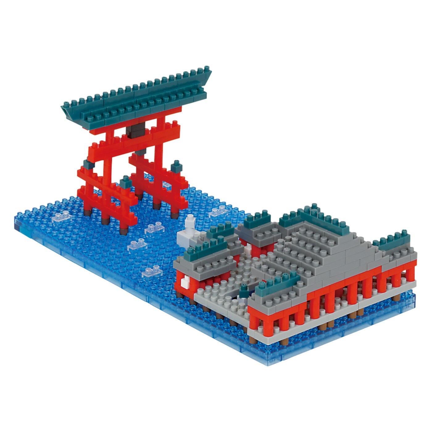 A colorful and intricate model of a Japanese-style gate or torii gate, composed of various building blocks in shades of red, blue, and gray.