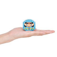 A hand holding a small blue, pixelated character with a face and eyes.