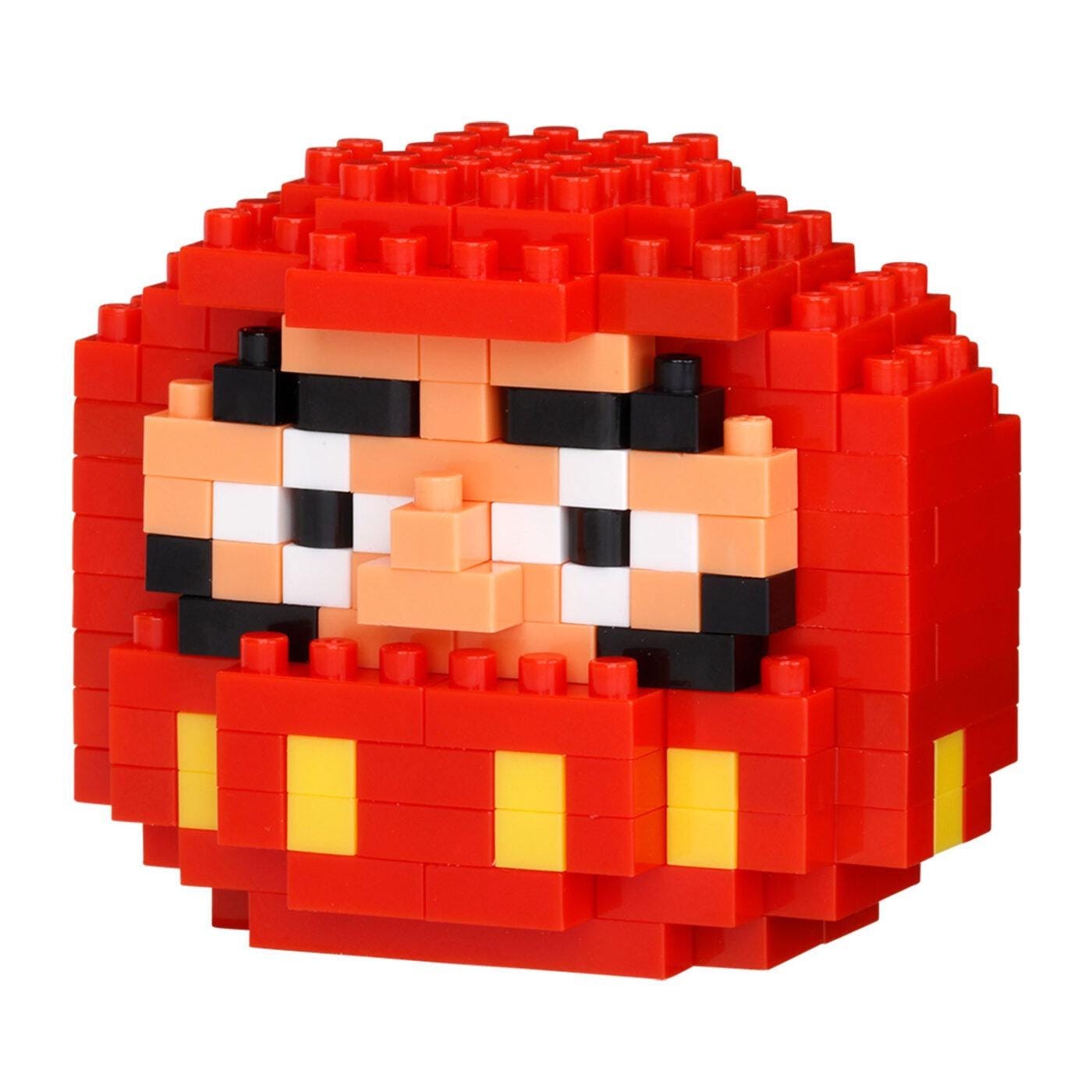 A red and yellow pixelated doll made of building blocks.