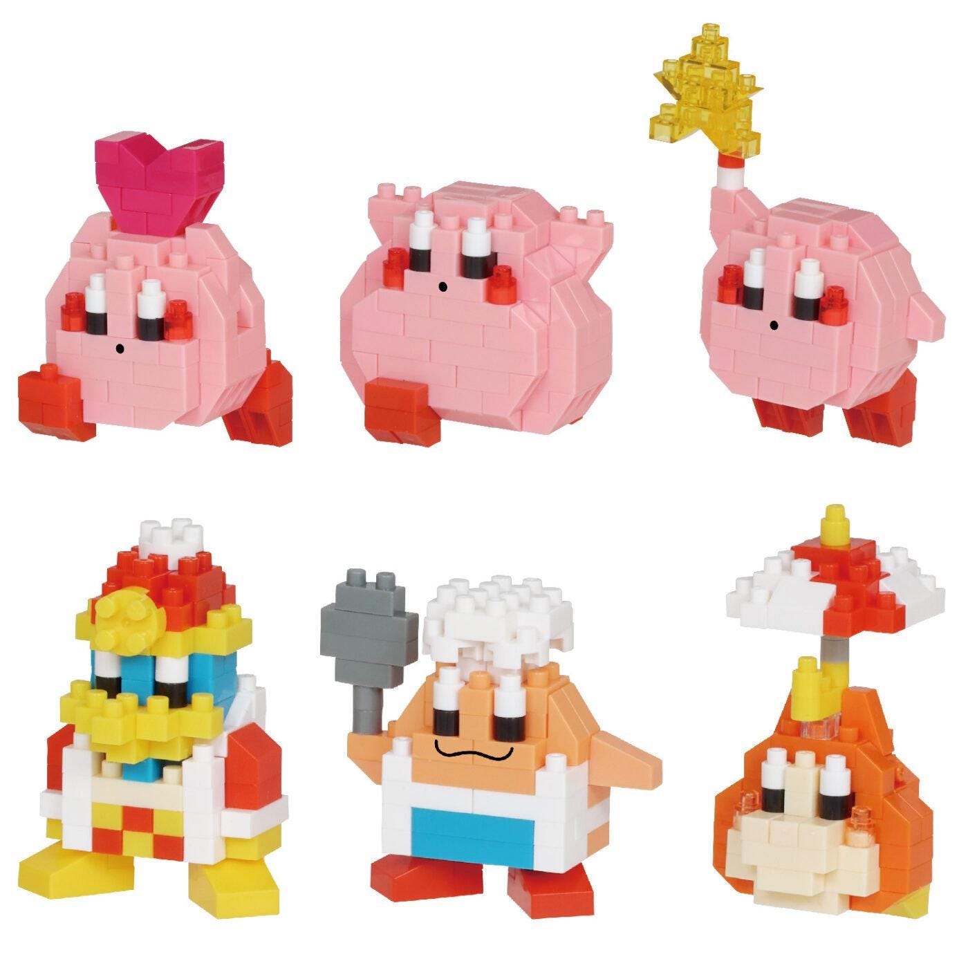 six colorful, pixelated character figurines, including a pink character with a heart-shaped headpiece, a pink character with a star-shaped headpiece, and a pink character with a red and white striped hat.