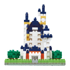 A colorful and intricate castle-like structure made of various building blocks, including trees and grass, creating a whimsical and imaginative scene.