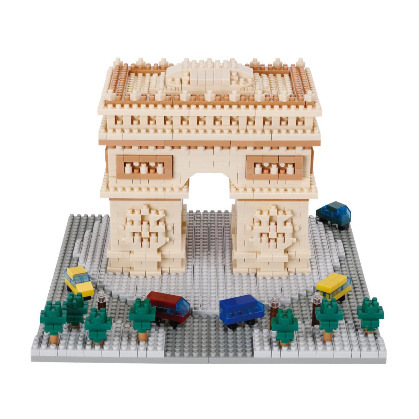 A model of the Arc de Triomphe made of Lego bricks, with various Lego vehicles and trees surrounding it.