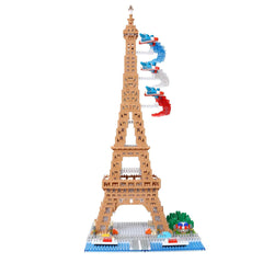 A tall, brown tower made of building blocks, resembling the Eiffel Tower, with a small tree and other decorative elements on the base.