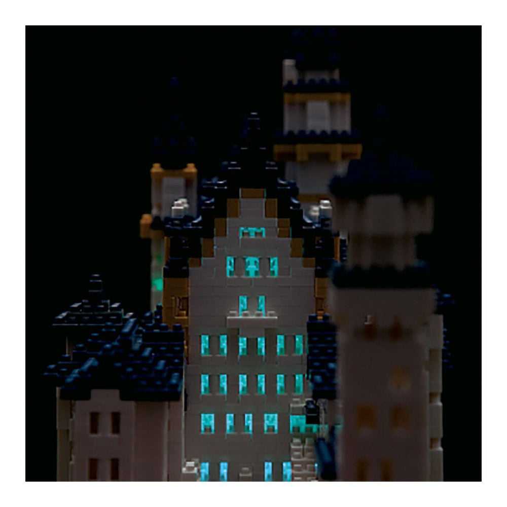 A close-up view of a model of a castle or palace, with intricate details and illuminated windows, creating a visually striking and detailed image.