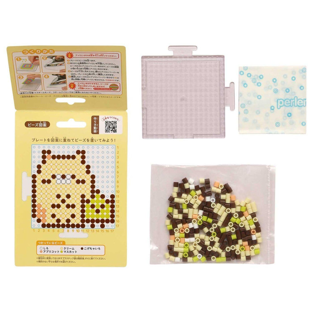 various items related to a pixel art design, including a yellow box with a picture of a pixel art character, a clear plastic container, and a bag filled with colorful beads.
