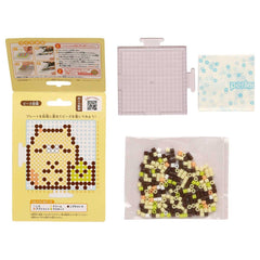 various items related to a pixel art design, including a yellow box with a picture of a pixel art character, a clear plastic container, and a bag filled with colorful beads.