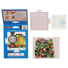 various items related to a craft or art project, including a blue box with instructions, a clear plastic container, and a bag filled with colorful beads.