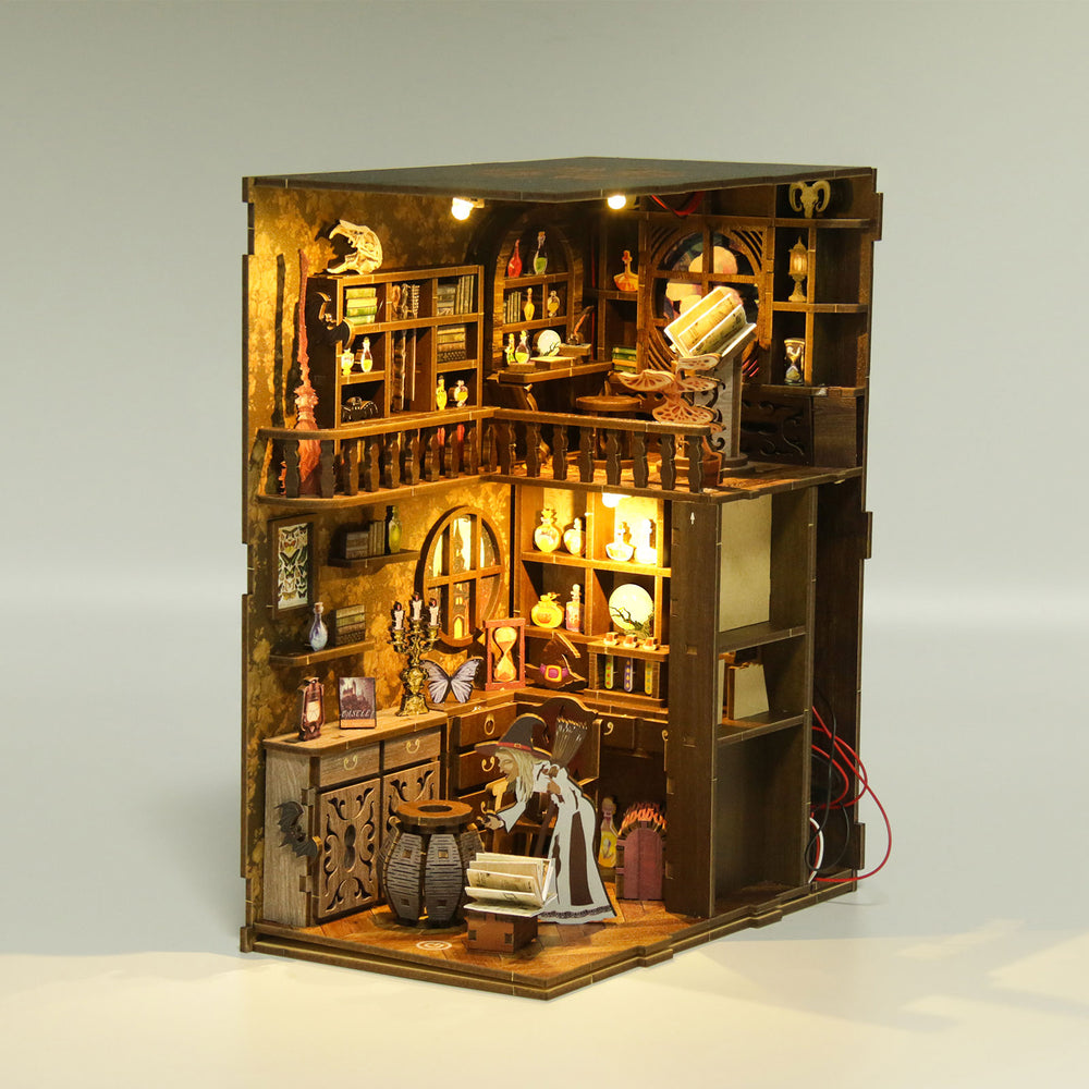 DIY book nook kit open cabinet with miniature kitchen shelves, table, and lit candles