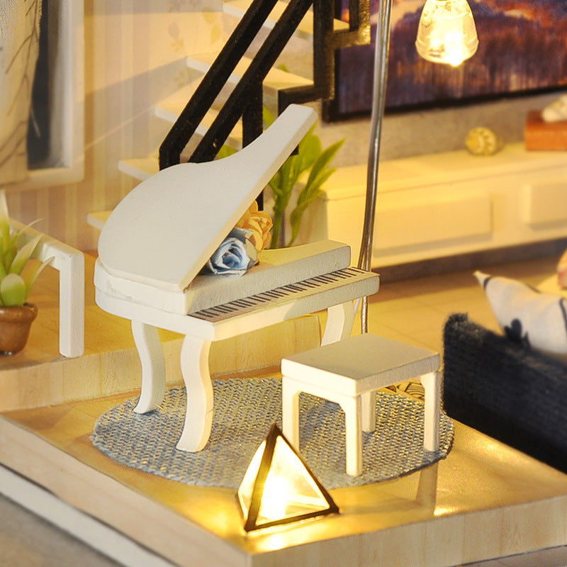 Miniature white piano with matching stool in dollhouse kit, warm LED lamp lighting