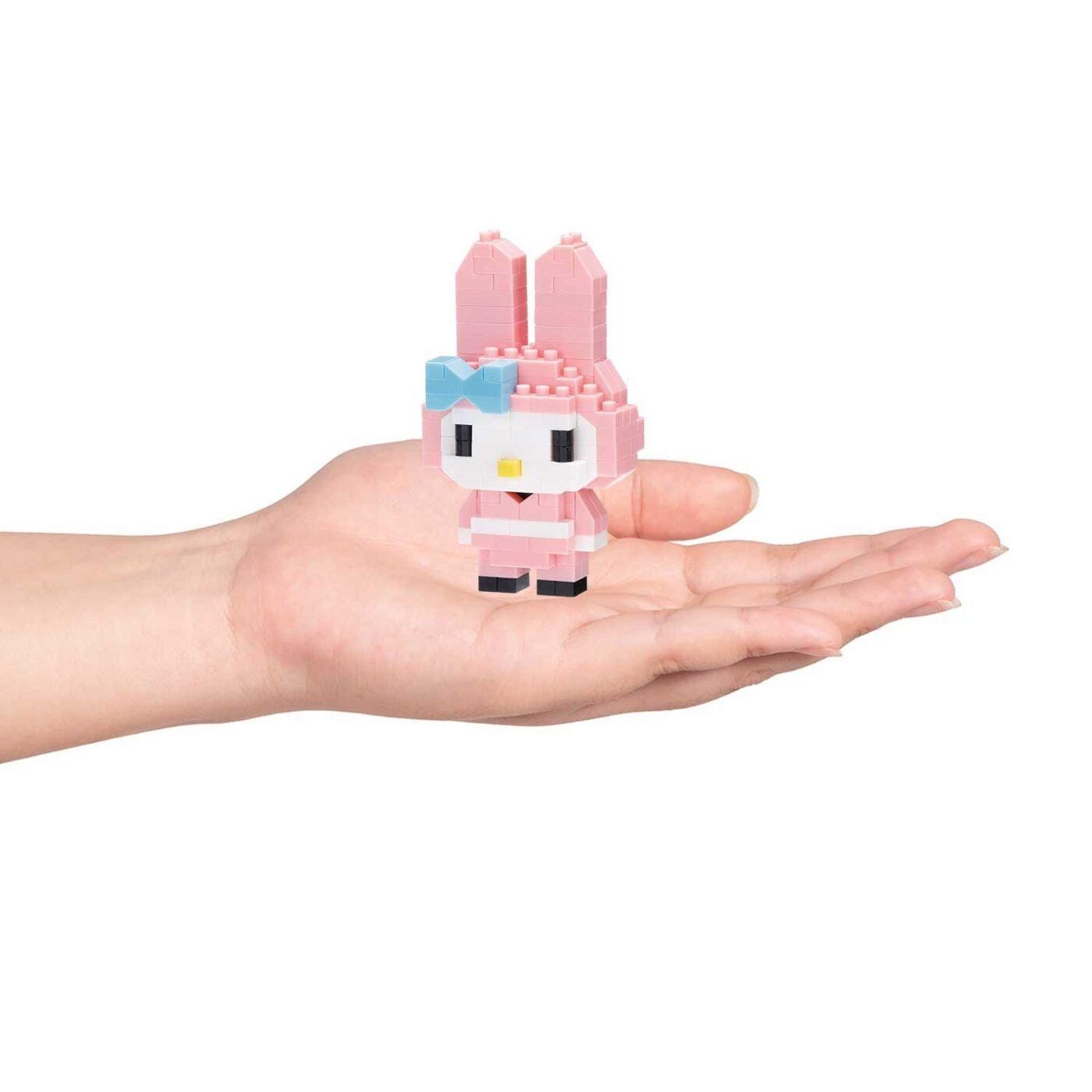 Pink nano building block rabbit ninja figurine held in a hand