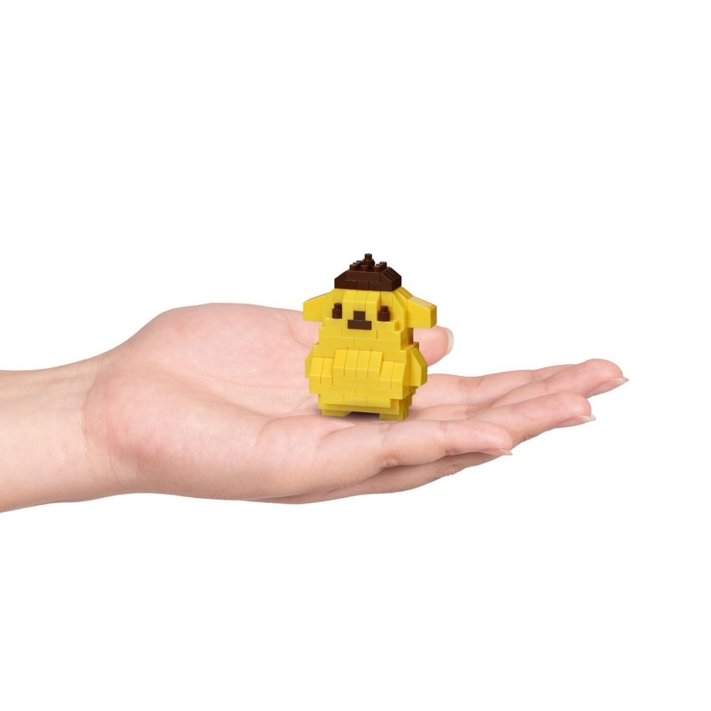 Yellow Pompompurin nano block character held in a hand