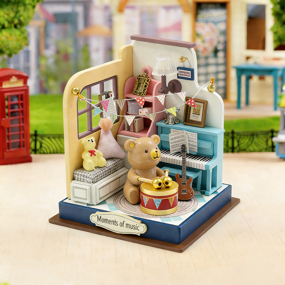 Miniature music room craft kit with teddy bear, piano, and drum on display