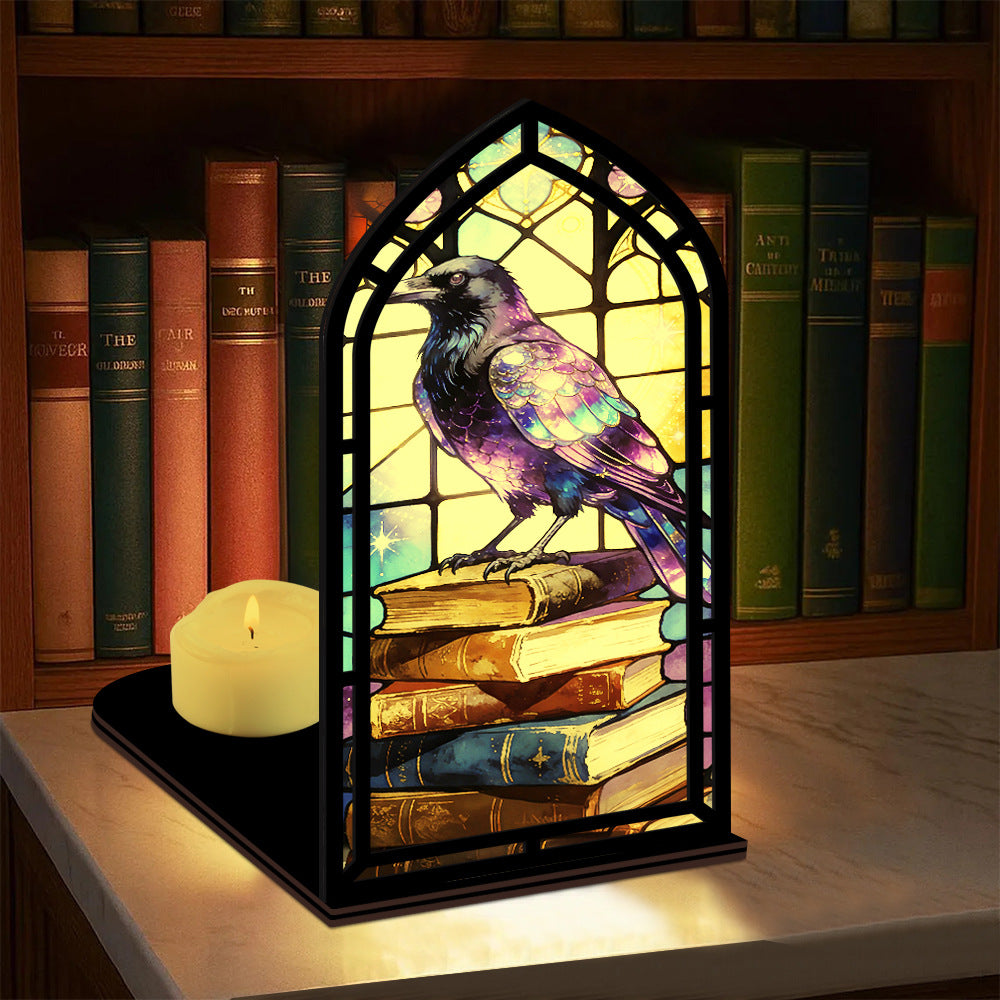 Arched book nook candle display with purple raven and small lit candle