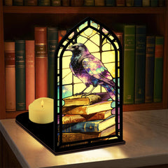 Arched book nook candle display with purple raven and small lit candle
