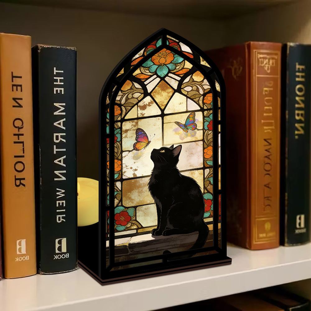 Stained glass arched book nook with black cat silhouette and butterfly window glow