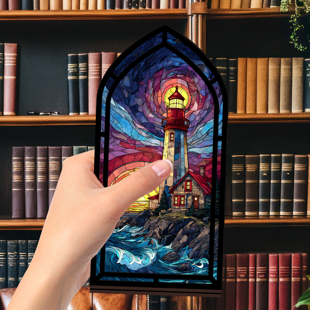 Coastal lighthouse book nook with stained-glass lighthouse panel, held up by a hand