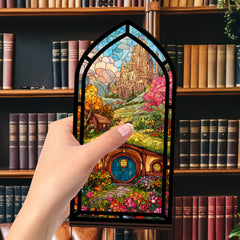 Arched book nook display with multicolor stained-glass style artwork and glowing interior light.
