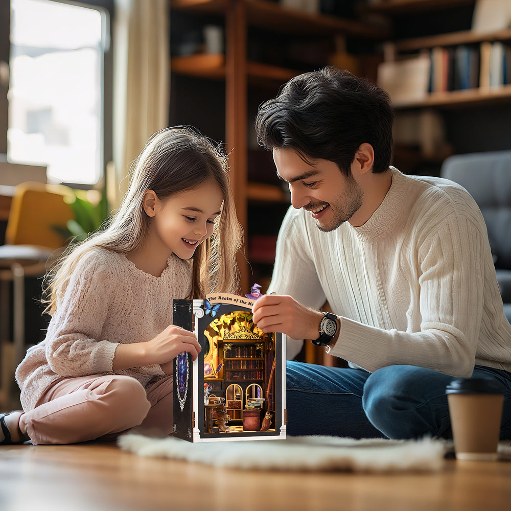 DIY miniature kit being assembled by a child and adult, open bookcase scene