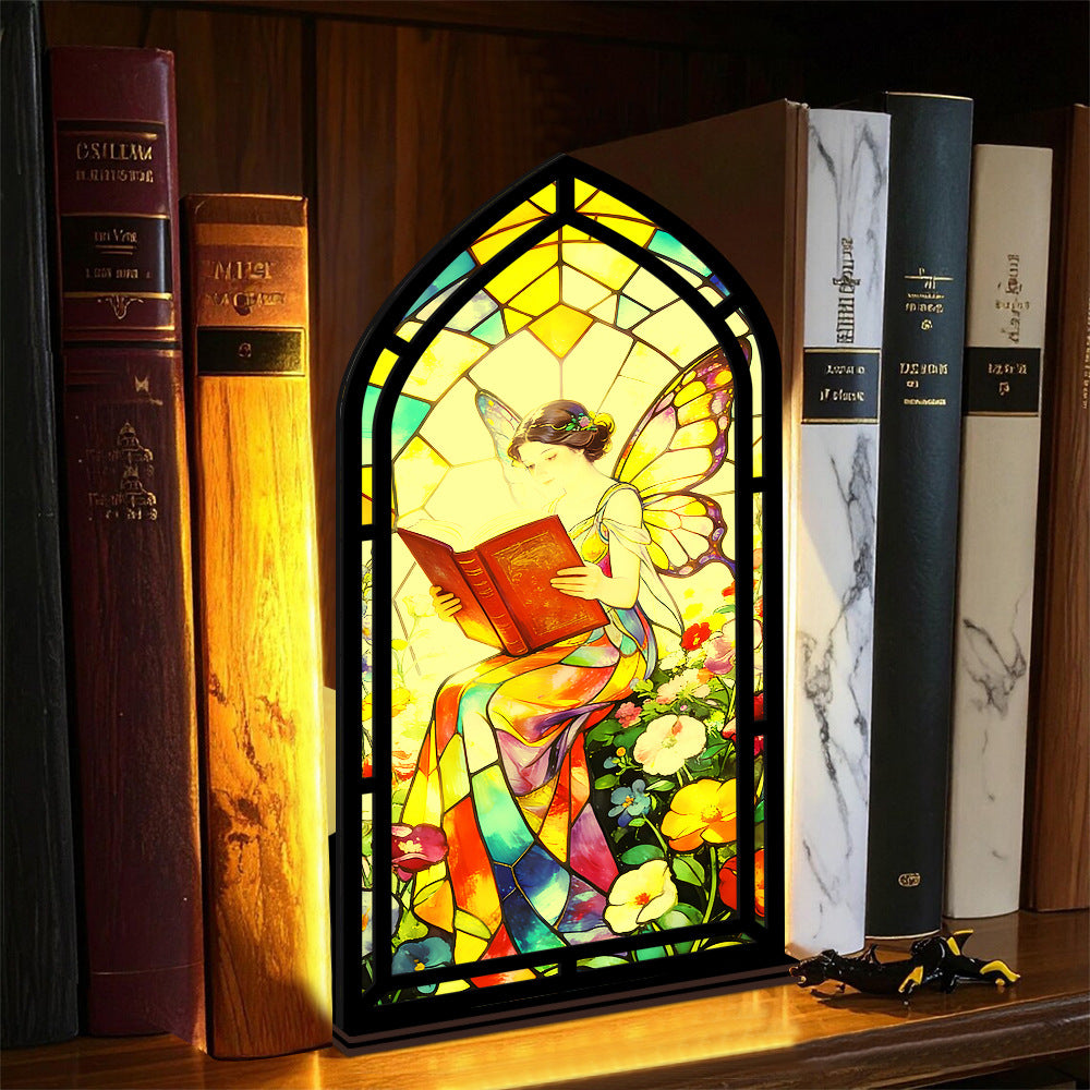 Stained glass fairy book nook with arched reading figure, black base and glowing side light